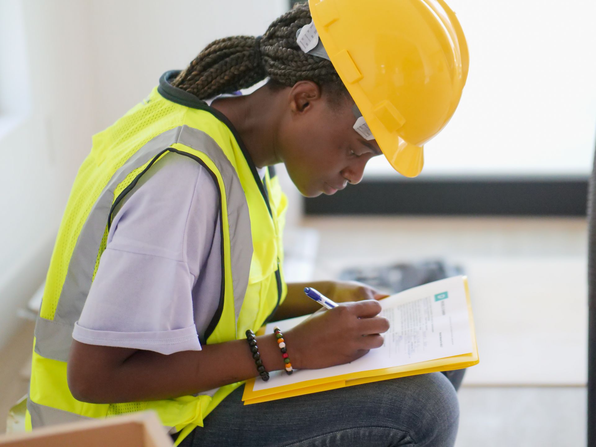 Metextra Africa engineer writing a technical report on site